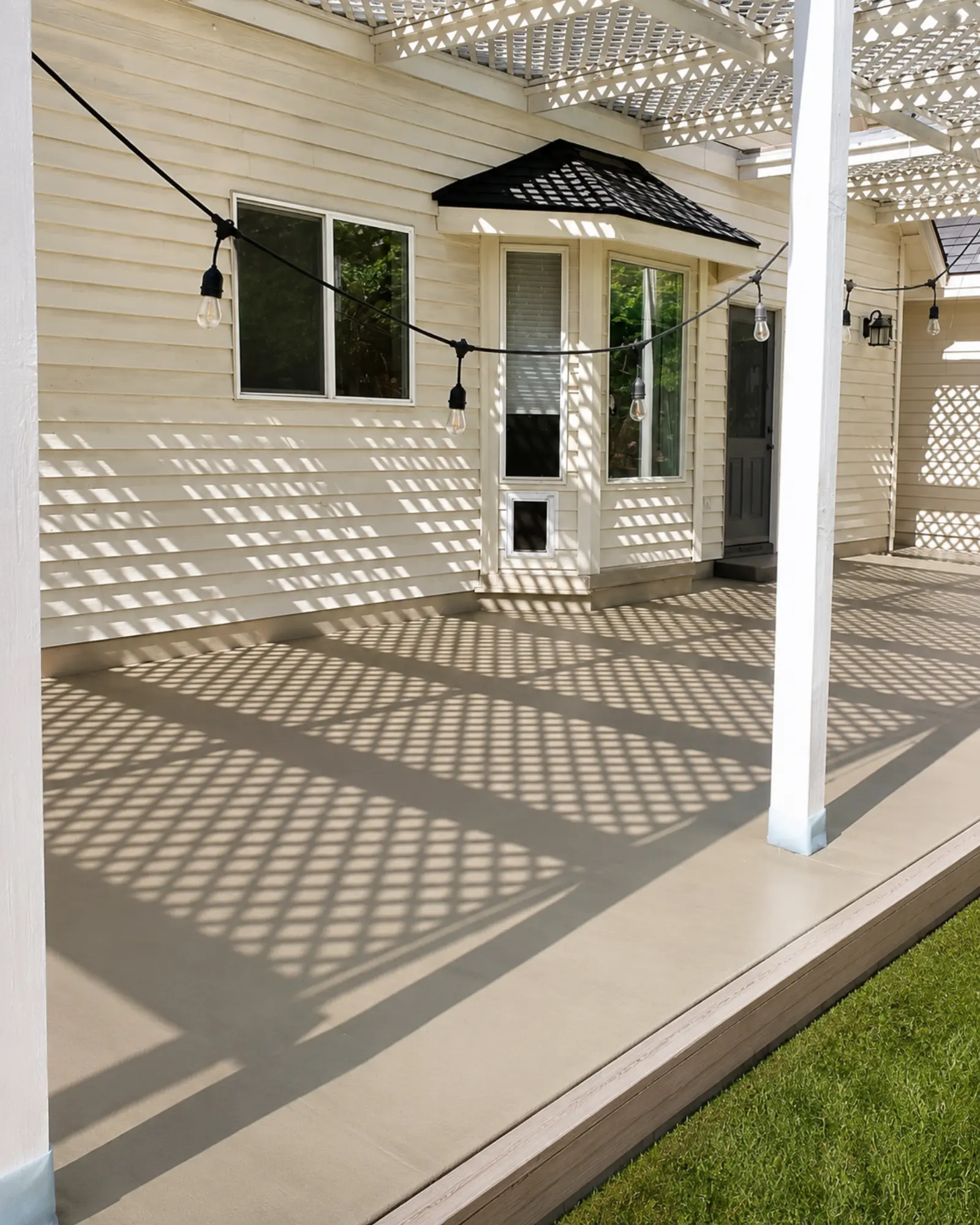 Finished concrete patio under the white pergola from an alternate angle by Almog Construction in Central Oregon.