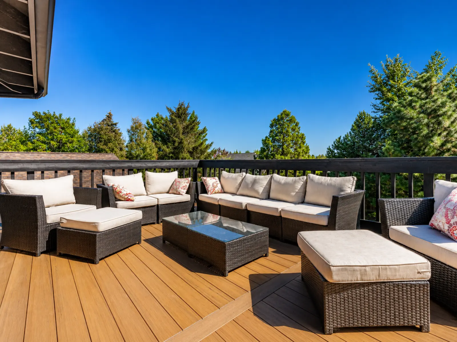 Sunny backyard deck with wicker furniture built by Almog Construction in Central Oregon.