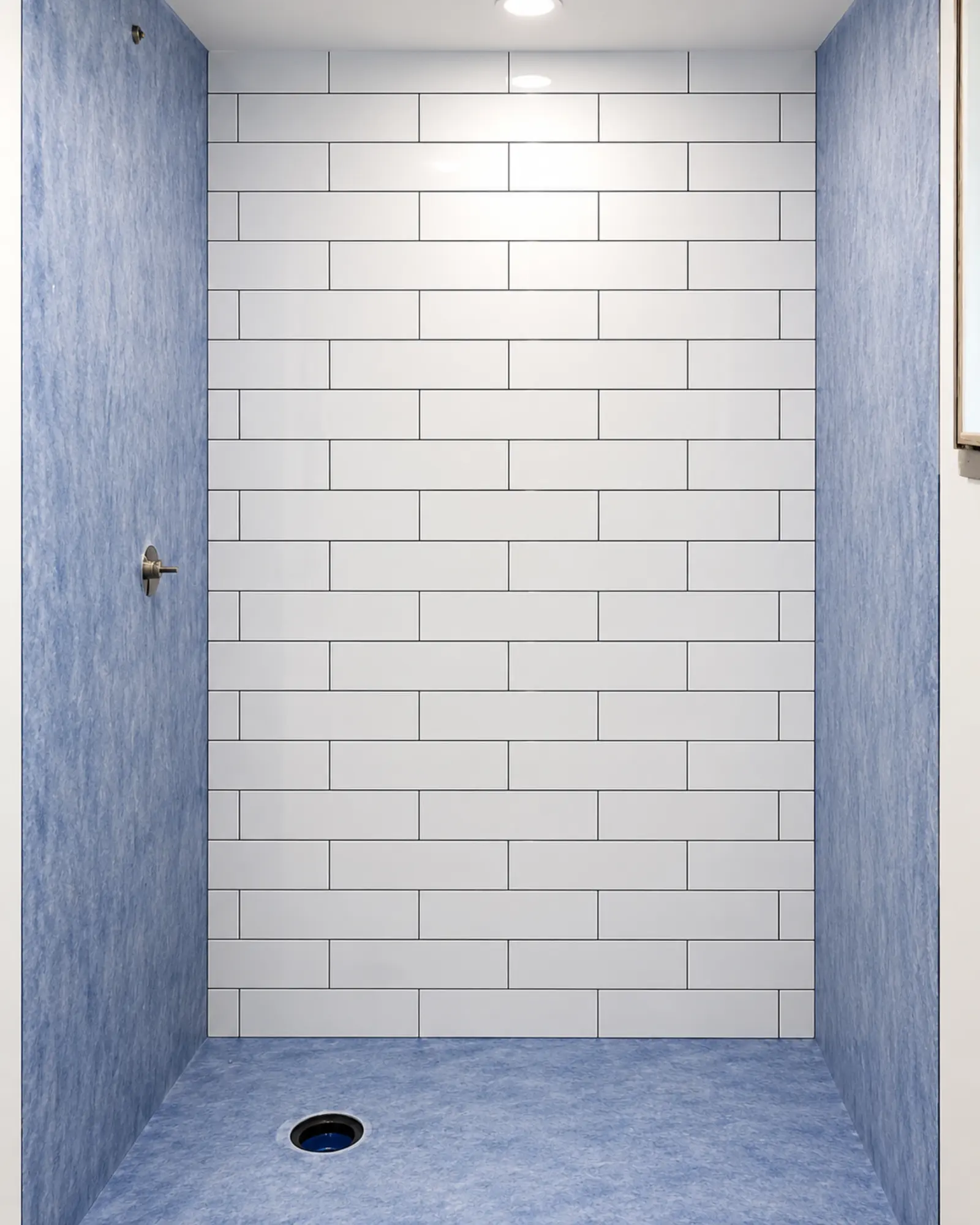 Bright tiled shower alcove under construction by Almog Construction.
