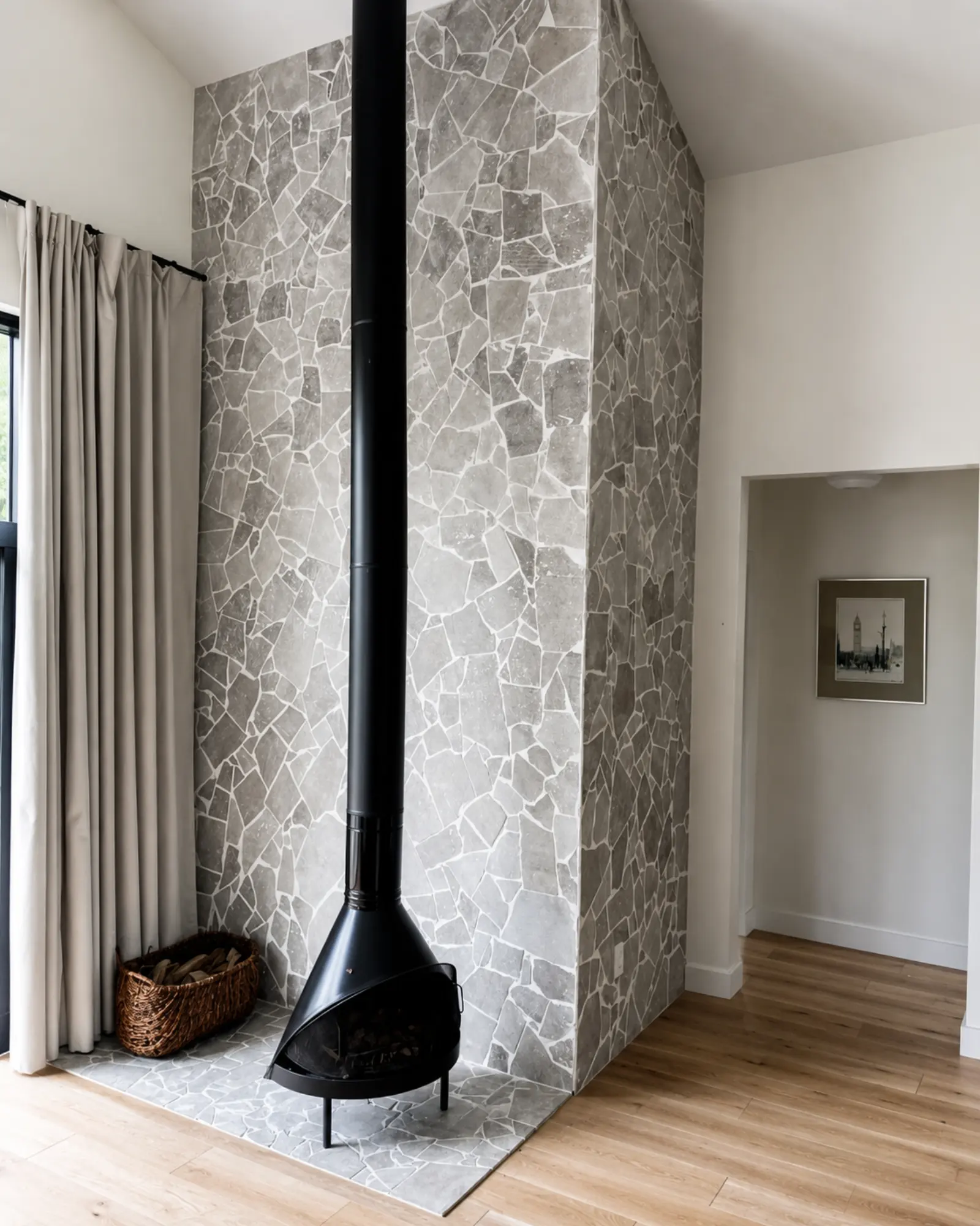 Minimalist living room with black wood stove renovated by Almog Construction.